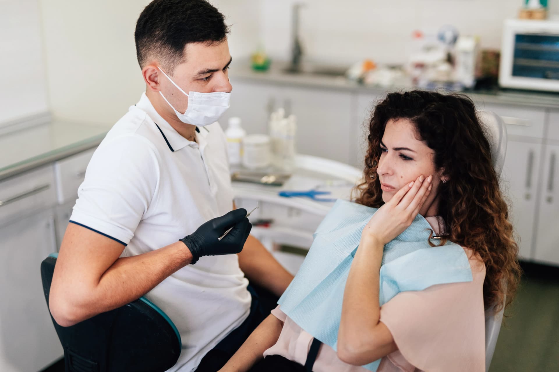 A patient in pain consulting with a dentist